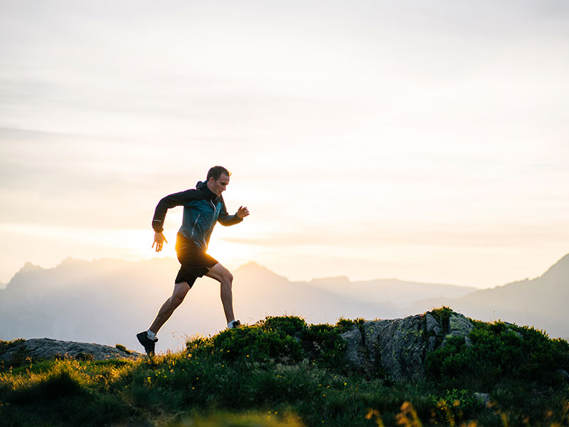 Man running up a mountain at the crack of dawn. He supplements his energy levels daily with CoQ10 which also works as an antioxidant.