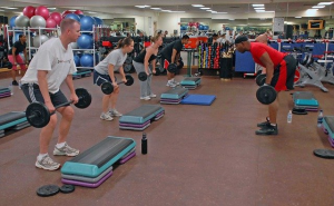 People lifting weights in a fitness center.